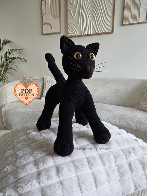 Hugo the black cat amigurumi crochet toy made using a PDF crochet pattern