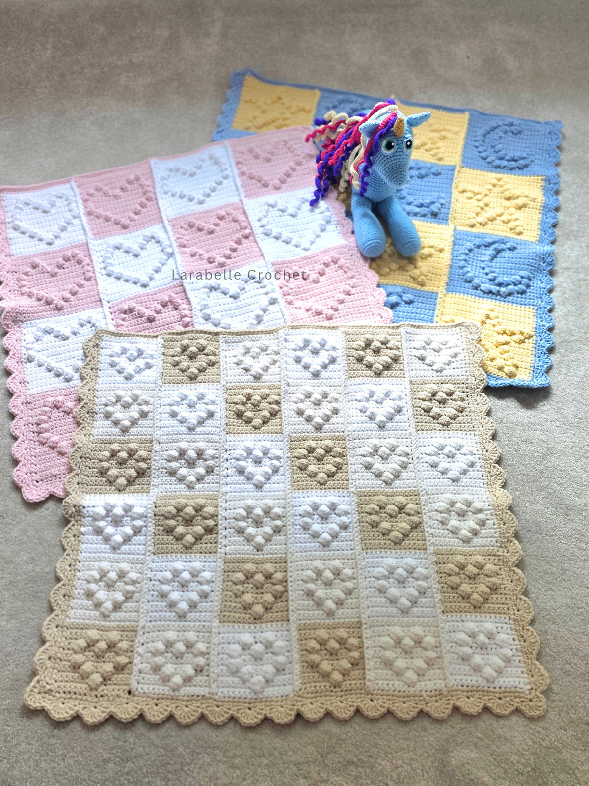 Collection of 3 baby blankets, one with small hearts, one with large hearts and one with starts and moons to suit all baby genders.