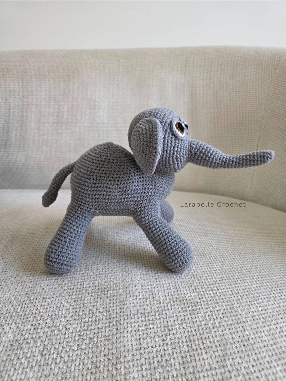 Side view of elephant crochet amigurumi with tail