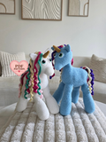 Lucian the blue unicorn and Aurora the white unicorn crochet amigurumi toys made using a PDF crochet pattern
