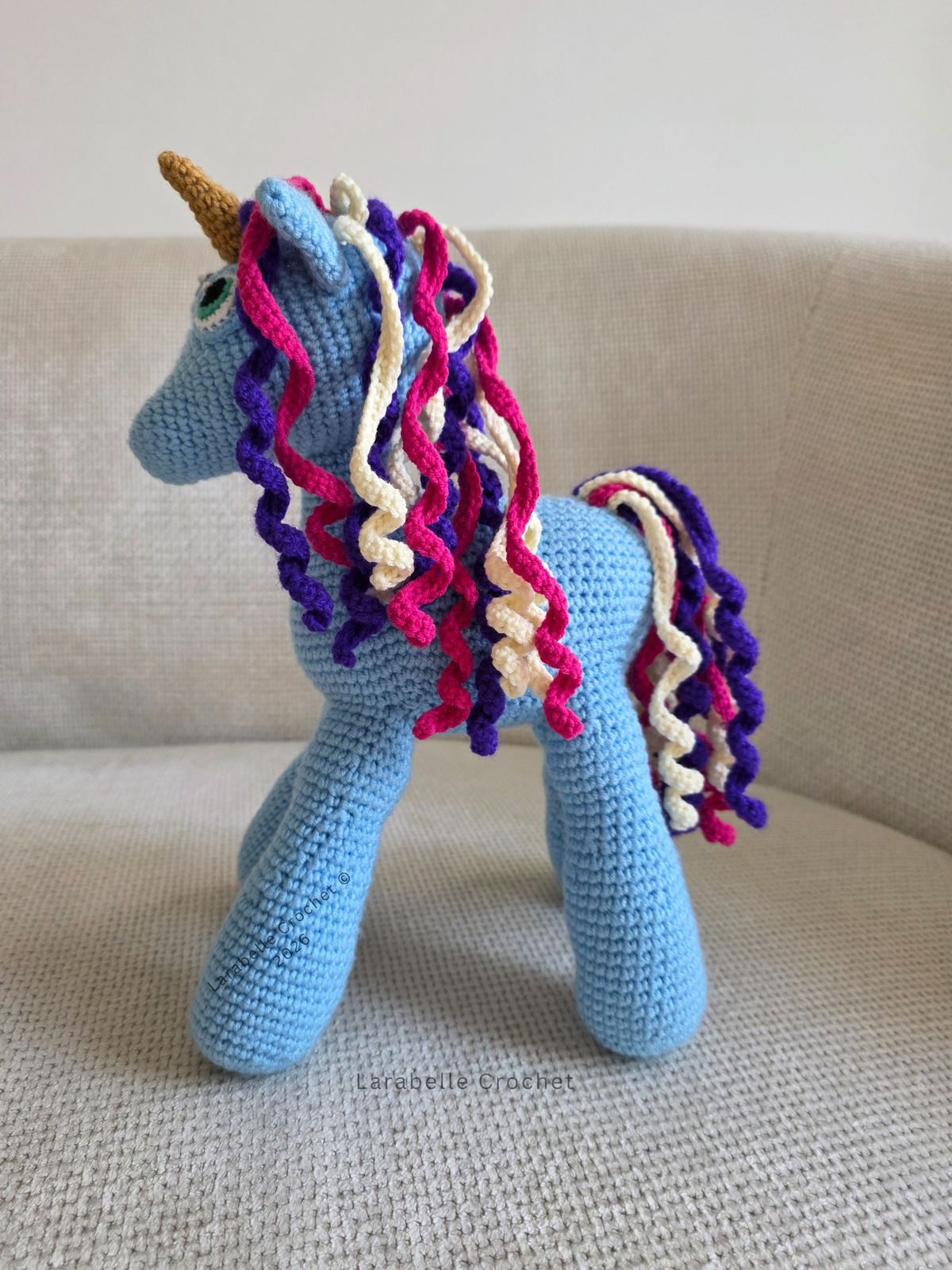 Side view of blue unicorn crochet amigurumi